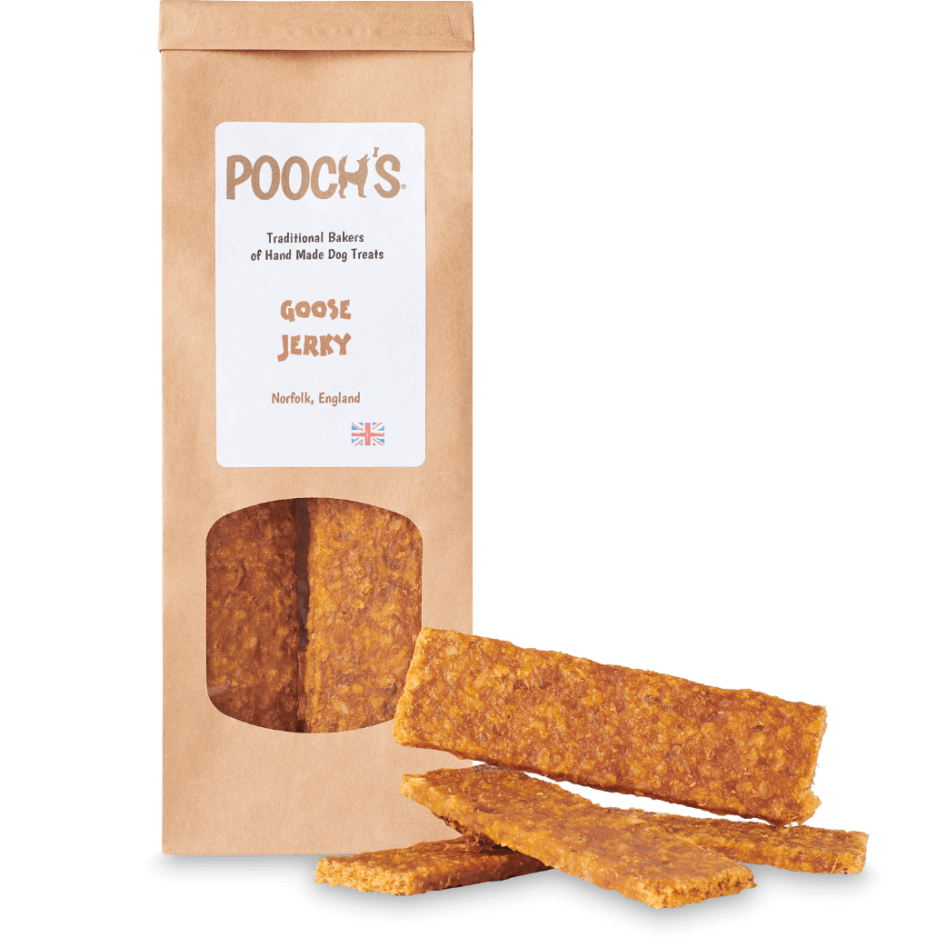 A package of Pooch's Goose Jerky with a window showing the jerky inside. There are also two pieces of the goose jerky visible outside of the package.