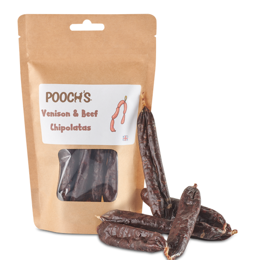Pouch of Pooch's Venison & Beef Chipolatas with dried chiles on a white background