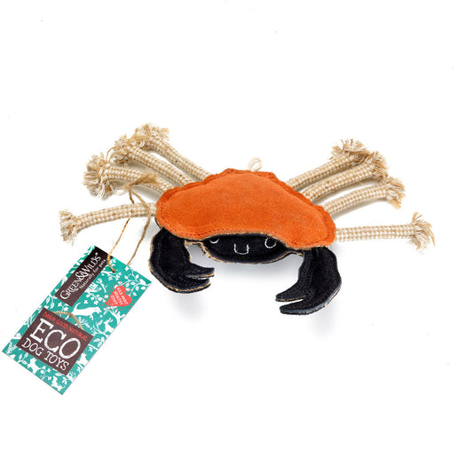 A plush toy crab with orange and black colors, featuring a suede outer covering and natural jute rope legs, with a label indicating it is an eco-toy.